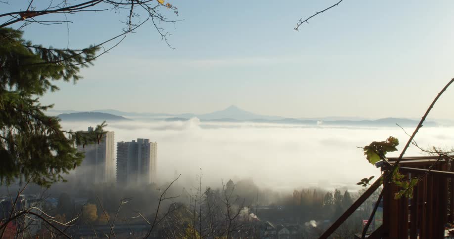 Cloud fog descending over a city view at daytime