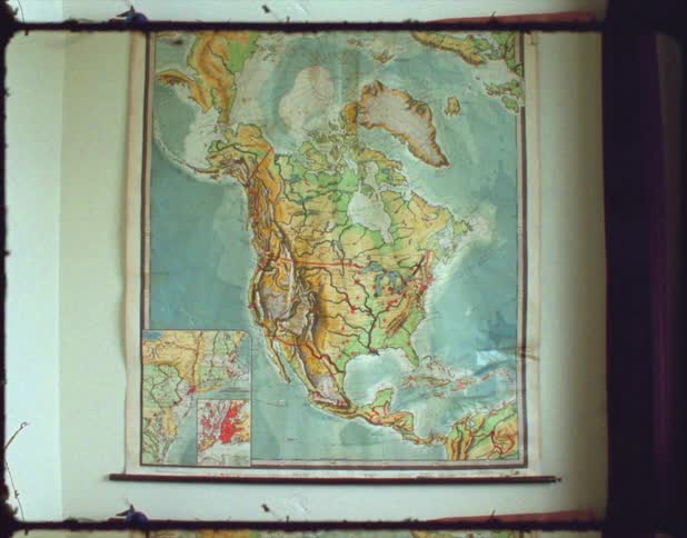 Large colorful map of north american continent hangs on wall