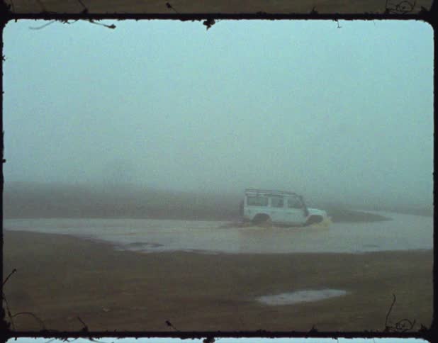 A vehicle is off roading through water