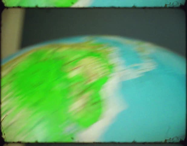 A small globe with the map of the planet earth is quickly rotated