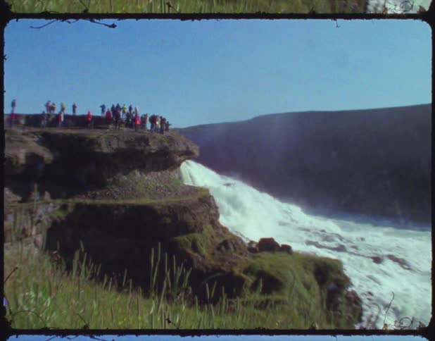 Group of tourists looking at gullfoss waterfall located in the canyon of the hvt river in southwest iceland