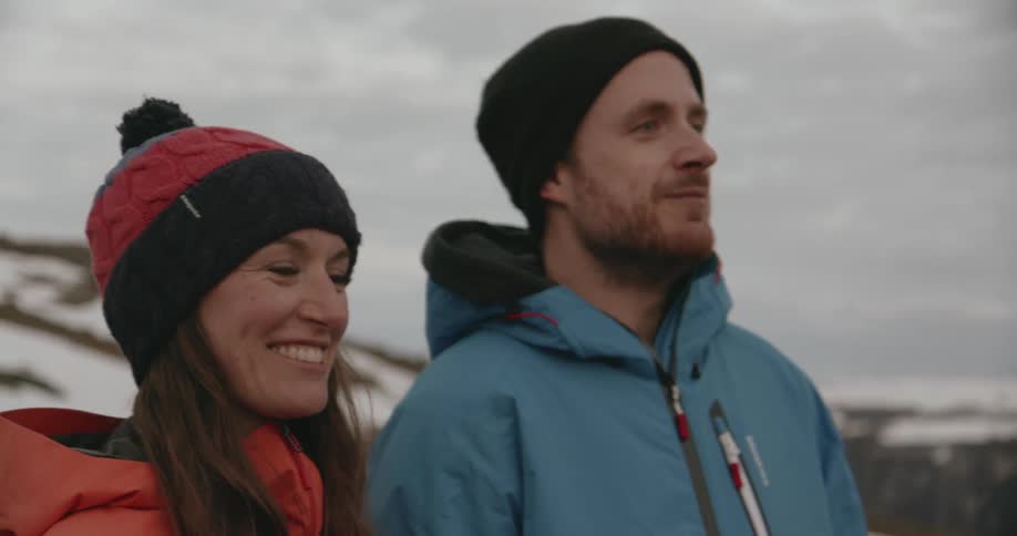 A man and woman smiling outdoors