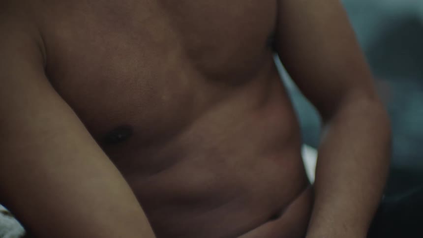 A man sitting with his shirt off
