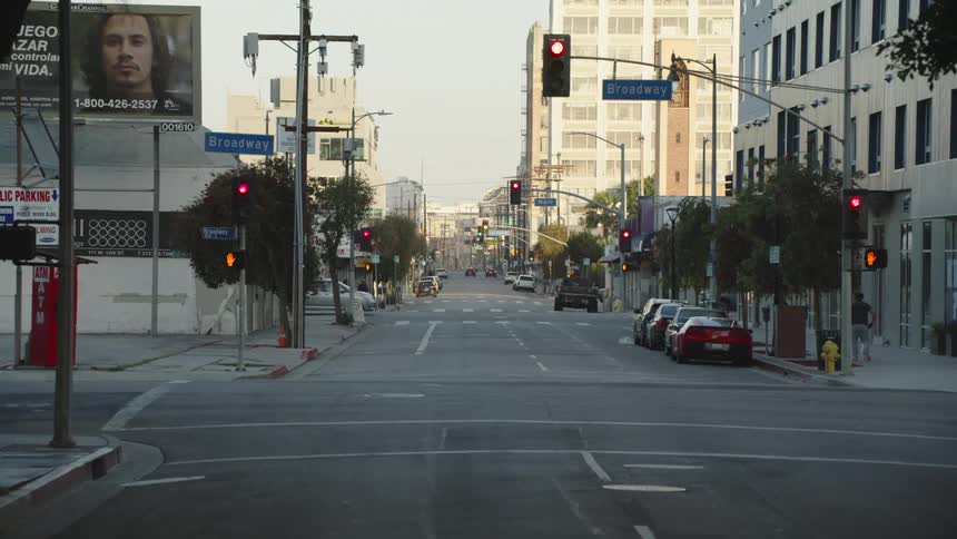 Low traffic on the intersection in an empty city main street in the morning