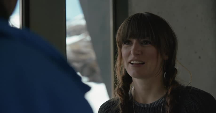 Woman smiling while talking to a man