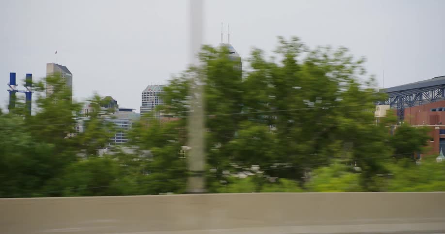 Skyline of tall skyscrapers on city downton seen from a moving car driving on the highway
