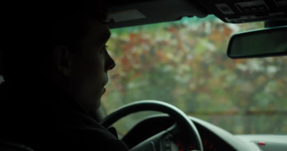 A young man driving a car