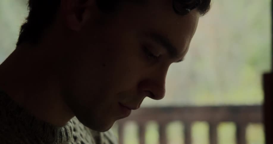 A man looks down as he concentrates