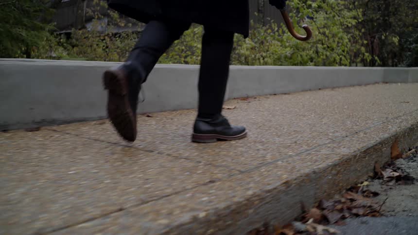 A man is walking outdoors in spring