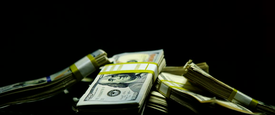 A close up of stacks of 100 dollar bills