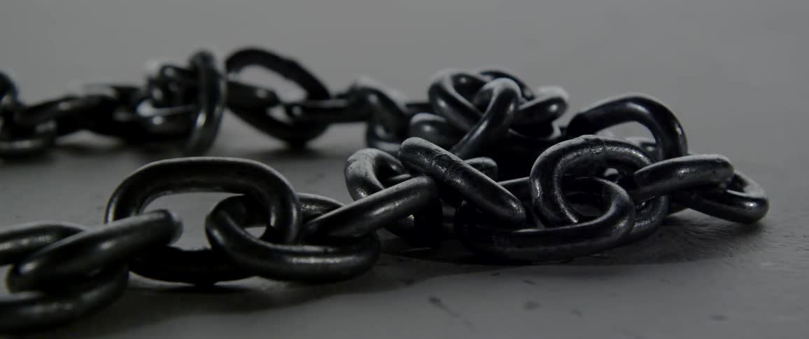 A chain lying on a cement floor