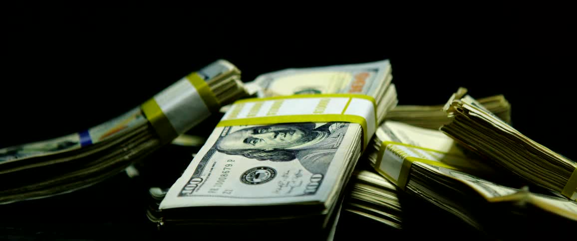 A pile of stacks of hundred dollars bills