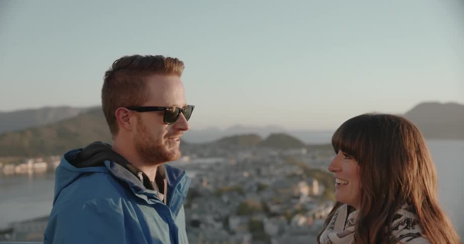 A man and women are chatting above a city below