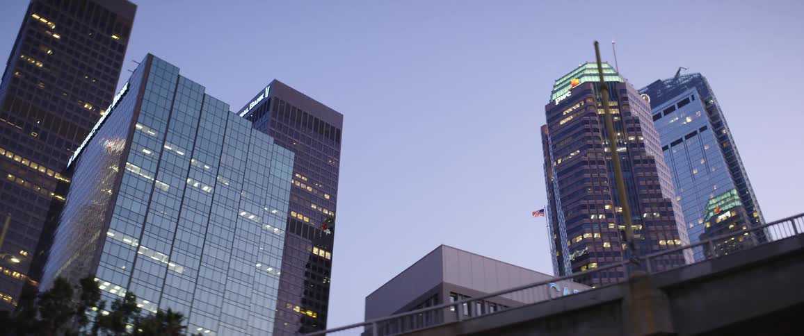 City buildings overpasses and reflections off buildings at dusk