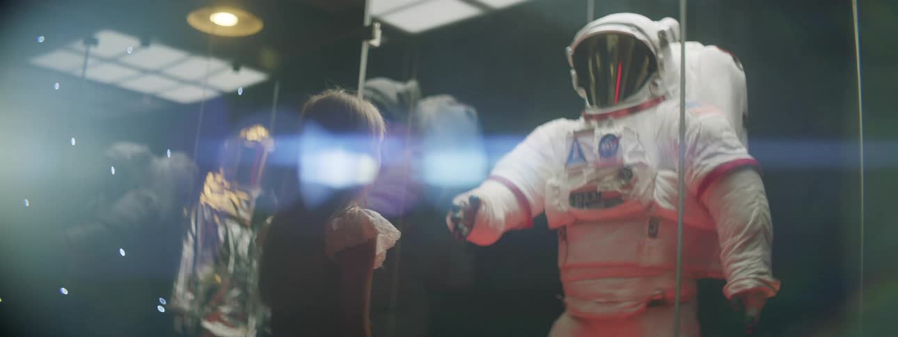 A student looking at a space suit