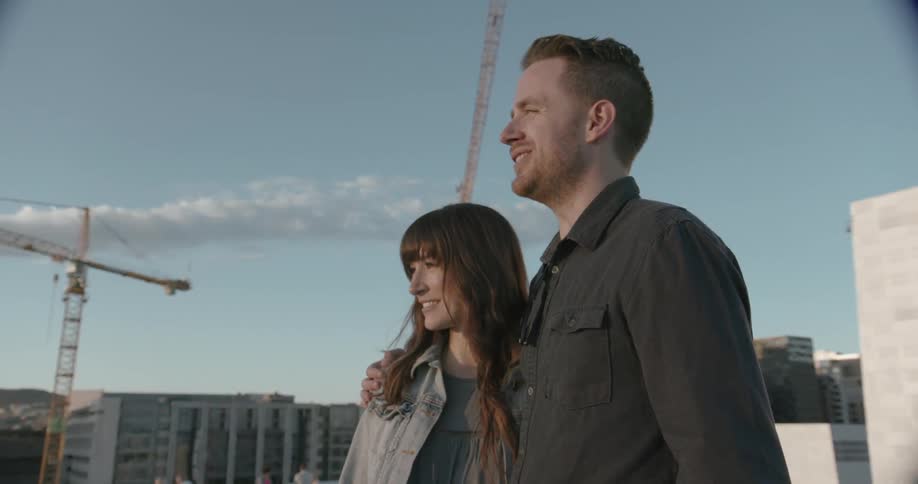 A man his his arm around a woman's shoulder as they talk