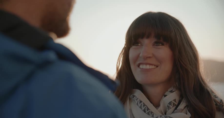 Woman smiling and talking to a man
