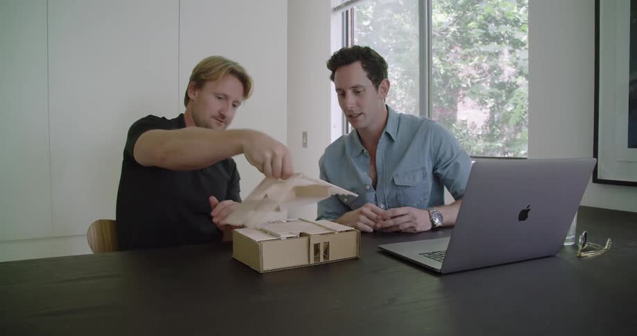 Two men are sitting in a room together