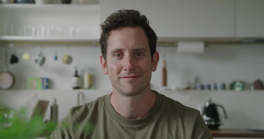 A man is smiling inside a room