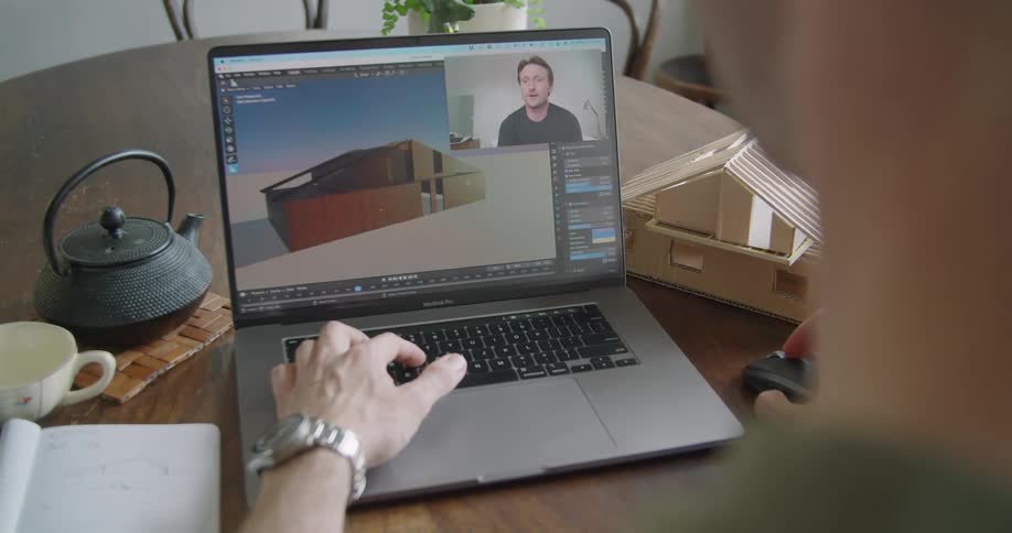 A person working in a game engine with a video call going