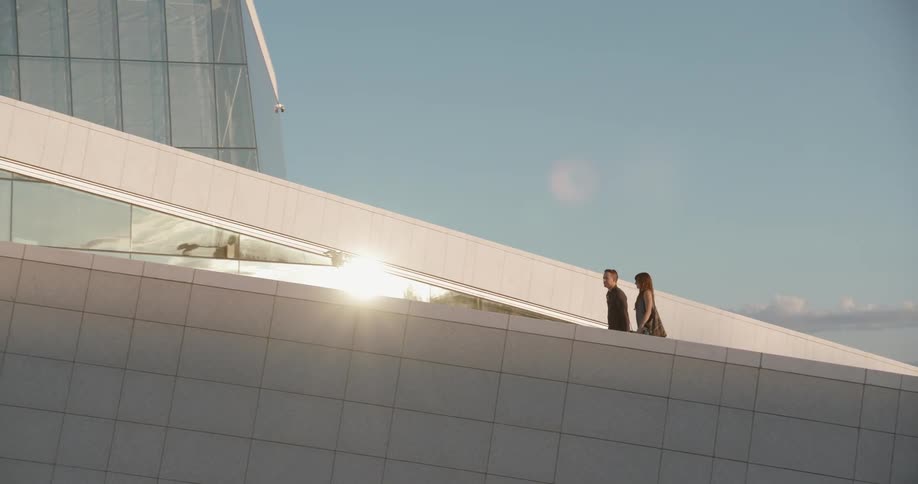 A man and woman walking up a ramp