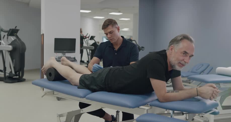 Senior citizen receiving an injection inside a physical therapy fitness center