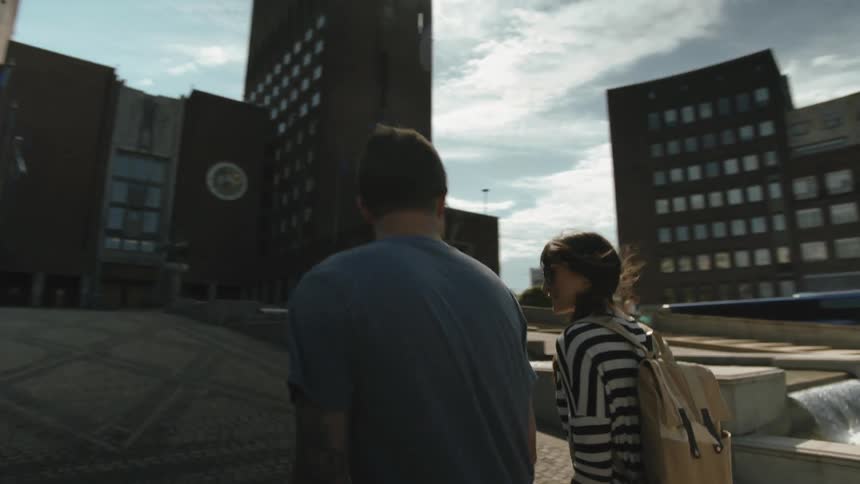 A man and woman walk up a ramp