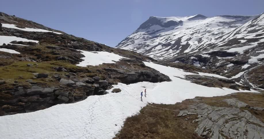 Two people are hiking on a mountain