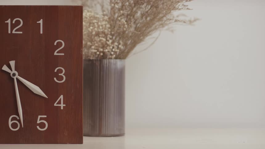 The clock counts next to the plant