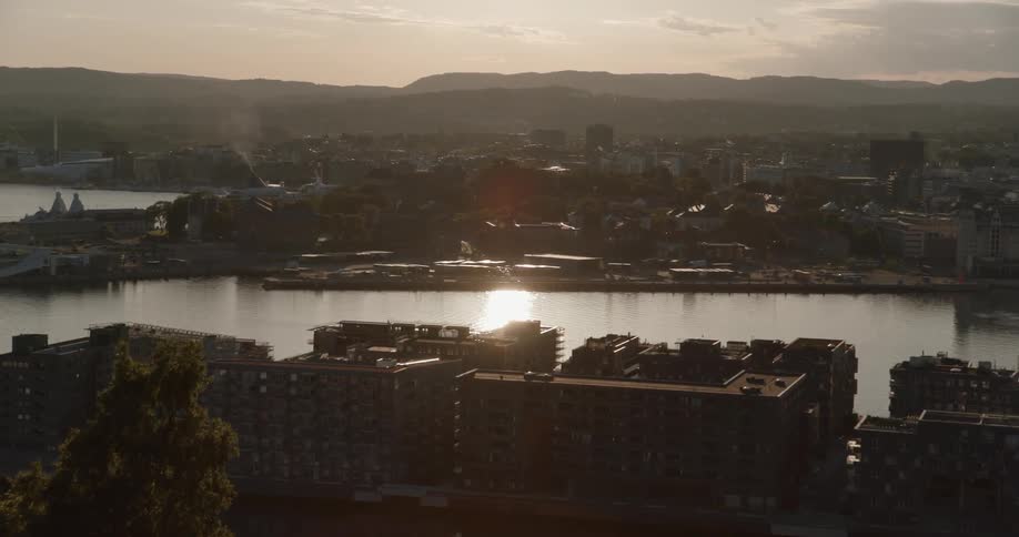 Body of water and city buildings at dawn