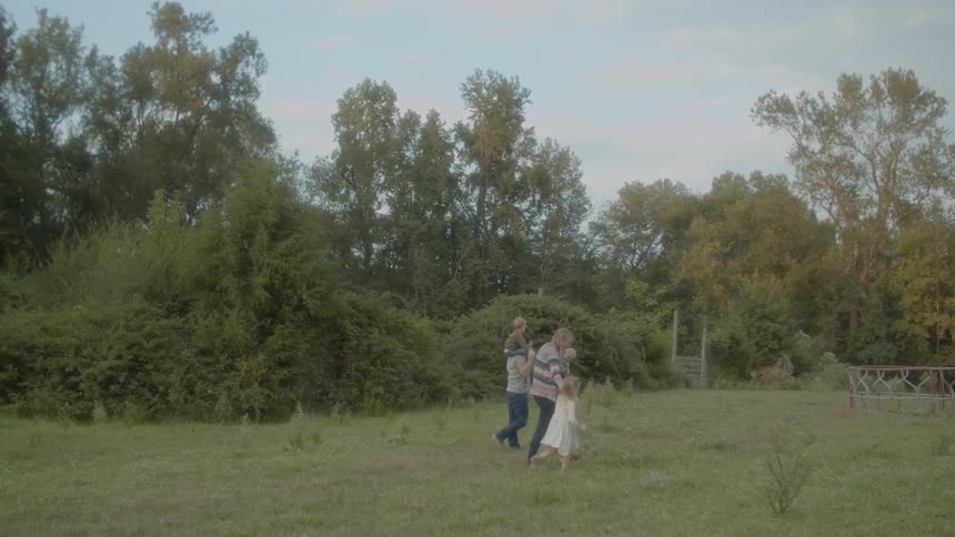 A family walking across a farm