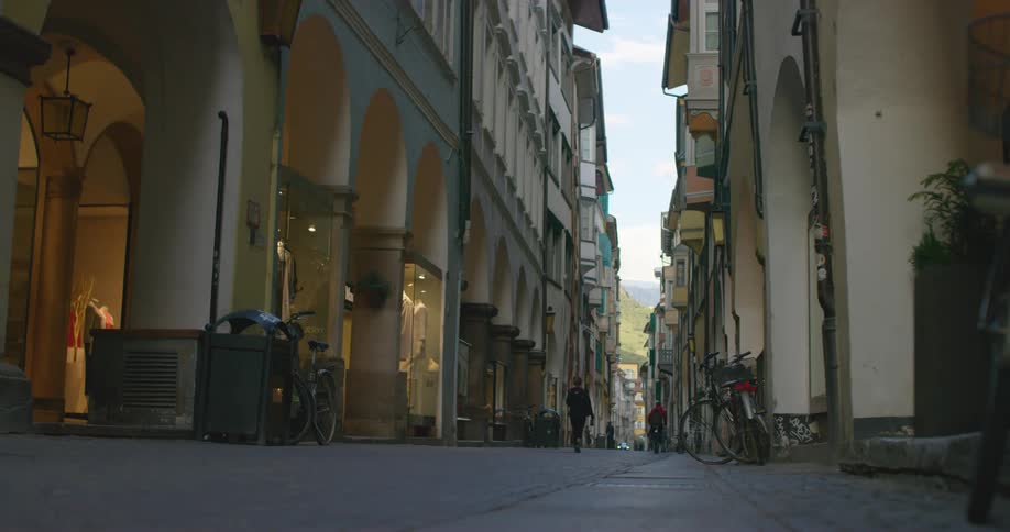People walk past the buildings in the city