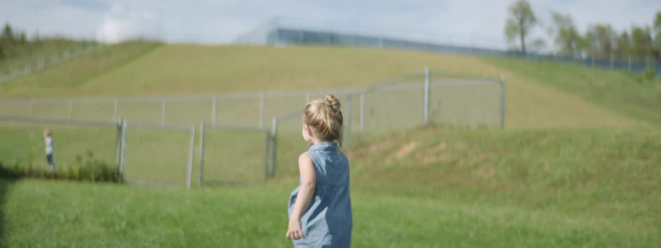 A child running towards a fence