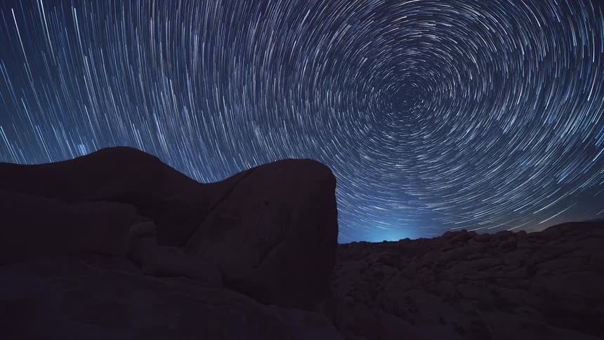 A time lapse of a shooting star in a sky filled with stars
