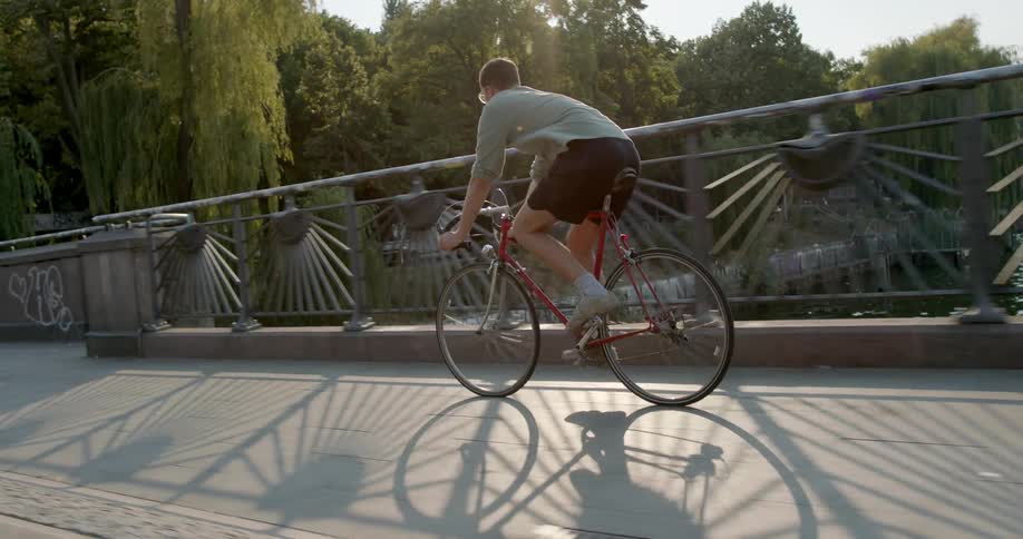 A person biking over a bridge