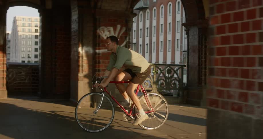 A man biking down a bridge
