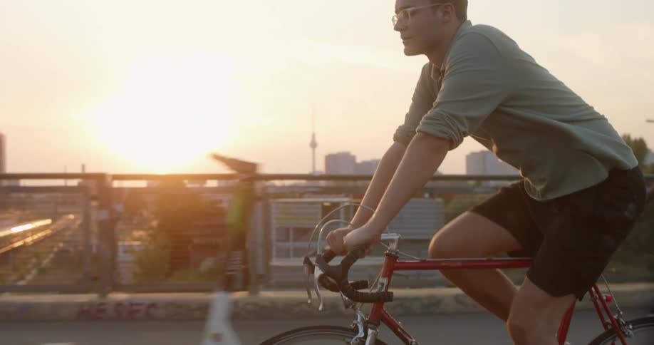 A man riding a bike on a bridge