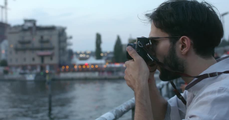 A man taking a photo of a river