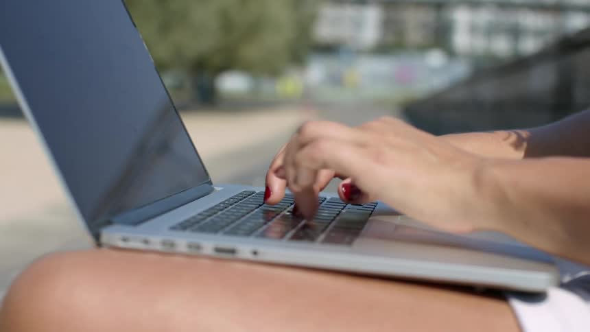 A person working on a laptop outside