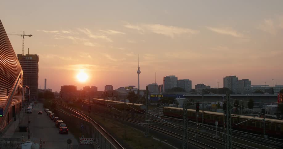 City view at sunset with trains in the foreground