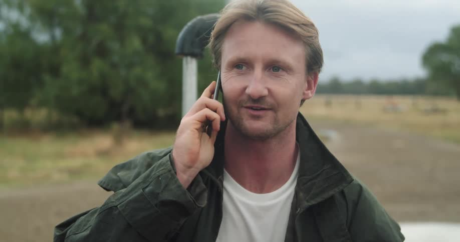 A man is talking on his phone outside