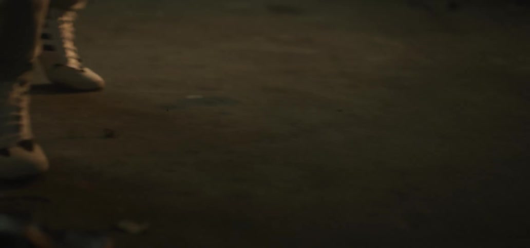 A man is boxing in an empty building at night