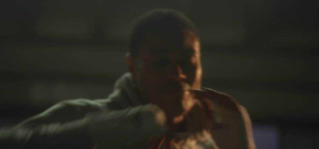 A man is boxing in a room at night