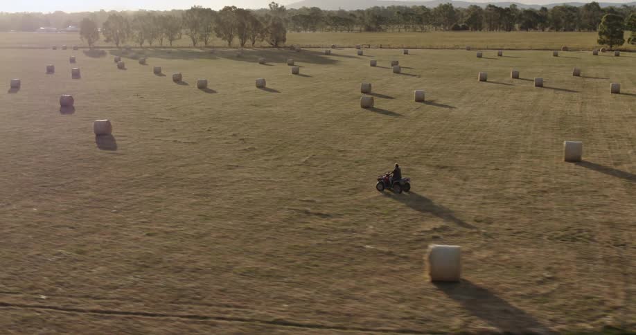 A person is riding their four wheeler over the farm land
