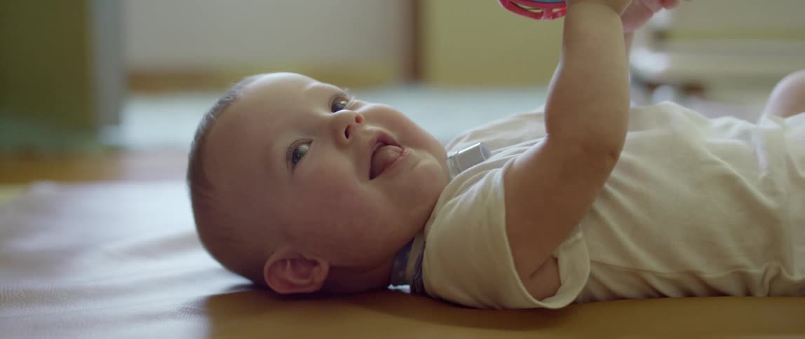 A baby playing with a ball