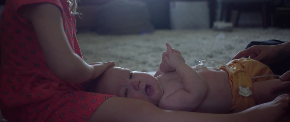 A child and toddler sitting on a floor