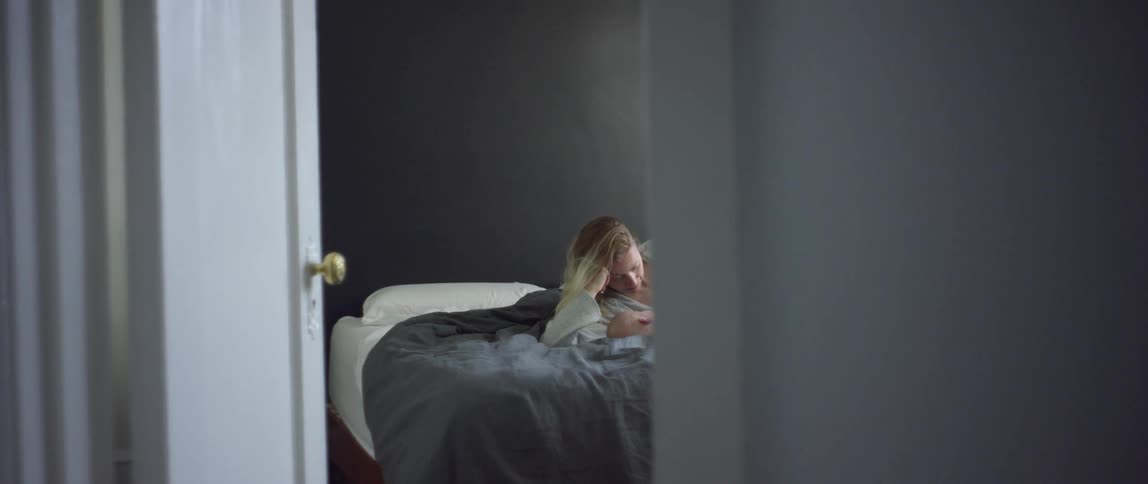 Mother lying on bed with baby