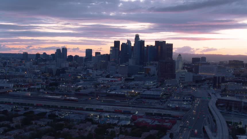Aerial view of a downtown city at dusk is displayed