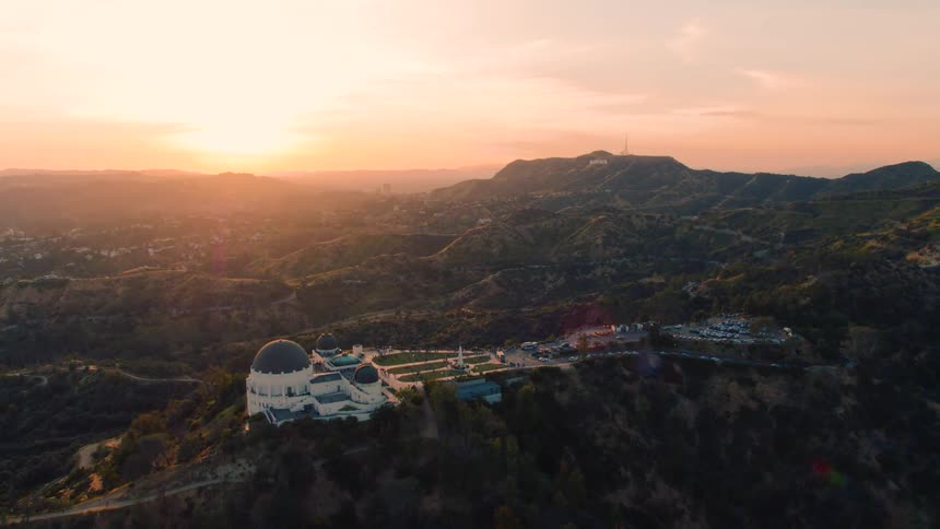 The parking lot is full at a large domed resort on top of a mountain in the countryside