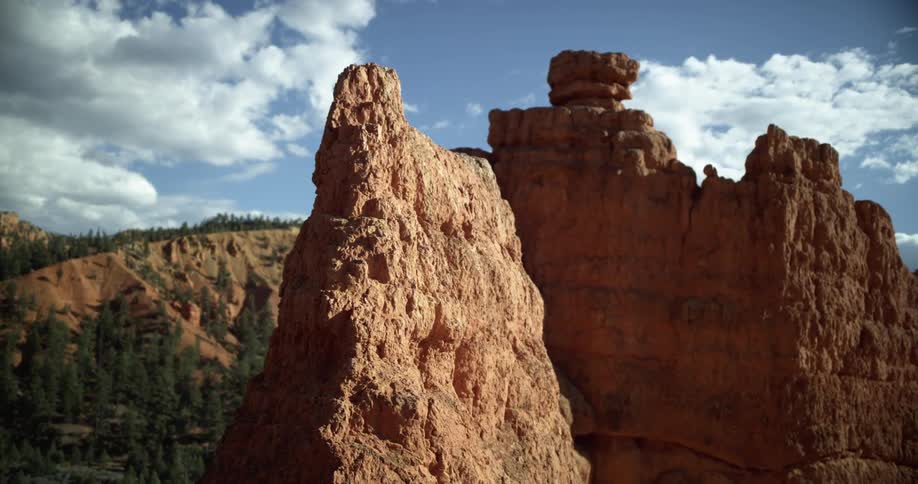 Mountain rock formations high into a cloudy sky